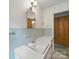 Bright bathroom featuring a white vanity with a sink and decorative light fixture at 220 Lakeview Dr, Belmont, NC 28012