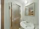 A well-lit bathroom includes a shower with glass door and vanity sink, providing essential amenities with classic styling at 220 Lakeview Dr, Belmont, NC 28012