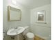 Traditional bathroom featuring a classic pedestal sink and mirrors, offering a clean and functional space at 220 Lakeview Dr, Belmont, NC 28012