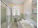 Tiled bathroom featuring a bathtub with shower and a white sink and toilet at 220 Lakeview Dr, Belmont, NC 28012