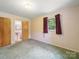 Bedroom featuring two closets and a window for natural light at 220 Lakeview Dr, Belmont, NC 28012