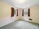 Cozy bedroom with two windows and green carpet at 220 Lakeview Dr, Belmont, NC 28012