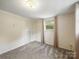 This bedroom features neutral walls, plush carpeting, a closet for storage, and a window that lets in natural light at 220 Lakeview Dr, Belmont, NC 28012