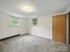 This bedroom features neutral walls, plush carpeting, a closet for storage, and two windows that lets in natural light at 220 Lakeview Dr, Belmont, NC 28012