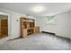 This room features neutral walls, plush carpeting, and a built in cabinet with a window at 220 Lakeview Dr, Belmont, NC 28012