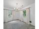 Bright dining room with chandelier, natural light and neutral color scheme at 220 Lakeview Dr, Belmont, NC 28012