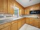 Bright kitchen with wood cabinets, granite countertops, and stainless-steel appliances at 220 Lakeview Dr, Belmont, NC 28012