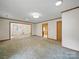 Spacious living room featuring neutral carpet, trim, and abundant natural light at 220 Lakeview Dr, Belmont, NC 28012