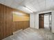 This room features wood paneling, plush carpeting, and a door that leads into another room at 220 Lakeview Dr, Belmont, NC 28012