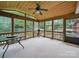 A view of the sunroom showcasing the windows, wood paneled ceiling, fan and table set at 220 Lakeview Dr, Belmont, NC 28012