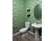 Charming powder room with green patterned wallpaper, modern fixtures, and stylish decor at 2485 Hedgecliff Rd, Kannapolis, NC 28025