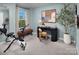 Light blue exercise room has stationary bike, desk, chair, and bench, creating a calming workout space at 2485 Hedgecliff Rd, Kannapolis, NC 28025