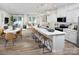 Open concept kitchen with island, seating, modern appliances, and seamless flow to the living area at 2485 Hedgecliff Rd, Kannapolis, NC 28025