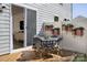 Stylish patio with dining table and chairs, complemented by hanging planters, perfect for outdoor enjoyment at 2485 Hedgecliff Rd, Kannapolis, NC 28025