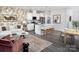 Open concept kitchen and living area with an island, white cabinets, stainless steel appliances and gray flooring at 3095 Big Bend Dr, Kannapolis, NC 28025