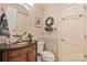 An elegant powder room featuring a unique vanity with a black countertop and decorative tile backsplash at 3500 Sunningdale Ln # 221, Statesville, NC 28625
