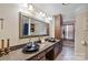 Well-lit bathroom with double sinks, dark wood cabinets, and granite countertops at 3500 Sunningdale Ln # 221, Statesville, NC 28625