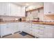Inviting kitchen featuring white cabinets, custom backsplash, and modern hardware at 3500 Sunningdale Ln # 221, Statesville, NC 28625