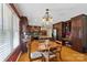 Spacious kitchen with hardwood floors, granite counters, and ample cabinet space next to a dining area at 3500 Sunningdale Ln # 221, Statesville, NC 28625