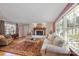 An inviting living room is filled with natural light, a brick fireplace, and a stylish rug to complete the space at 3500 Sunningdale Ln # 221, Statesville, NC 28625