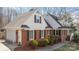 Side view of brick home with attached garage, dormer windows, and mature landscaping at 3500 Sunningdale Ln # 221, Statesville, NC 28625
