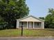 Charming single-story home with gray siding, a welcoming front porch, and a well-maintained lawn at 38 Holly St, Great Falls, SC 29055