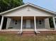 Classic front porch view featuring a clean facade, and traditional architectural details at 38 Holly St, Great Falls, SC 29055