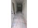 Long hallway with unfinished floors and visible framing, offering a glimpse into the home's layout at 38 Holly St, Great Falls, SC 29055