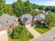 Aerial view of a lovely home with a paved driveway, lush landscaping, and a well-manicured lawn at 4004 Saint Andrews Ct, Cramerton, NC 28032