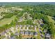 A serene, elevated view of homes in a golf course community, enveloped by abundant trees and greenery at 4004 Saint Andrews Ct, Cramerton, NC 28032