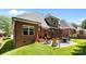 Brick home's backyard oasis features a patio, barbecue, and outdoor seating for delightful gatherings at 4004 Saint Andrews Ct, Cramerton, NC 28032