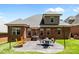 Beautiful backyard with a well-kept lawn, patio, and outdoor seating, perfect for relaxation and entertaining at 4004 Saint Andrews Ct, Cramerton, NC 28032