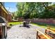 Lovely backyard boasts a seating area, brick accents, lush greenery, and a private outdoor space at 4004 Saint Andrews Ct, Cramerton, NC 28032