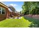 Spacious backyard with lush green grass, a patio area, and mature trees, perfect for outdoor living at 4004 Saint Andrews Ct, Cramerton, NC 28032