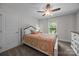 Bedroom with white trim, plush carpet, ceiling fan, and large window providing natural light at 4004 Saint Andrews Ct, Cramerton, NC 28032
