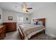 Bedroom featuring ceiling fan, a wooden dresser, and a window bringing in lots of light at 4004 Saint Andrews Ct, Cramerton, NC 28032
