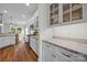Bright kitchen features granite counters, wooden floors and glass front cabinetry at 4004 Saint Andrews Ct, Cramerton, NC 28032