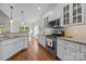 Bright kitchen features granite counters, stainless appliances and wooden floors at 4004 Saint Andrews Ct, Cramerton, NC 28032