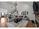 Living room with high ceilings, staircase and a large chandelier at 4004 Saint Andrews Ct, Cramerton, NC 28032