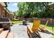 Back patio features a stone grill, chairs, and plenty of greenery at 4004 Saint Andrews Ct, Cramerton, NC 28032