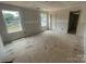Bright bedroom featuring two windows, and doorway to another room at 4040 Grommet Ct, Matthews, NC 28105