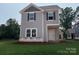 New construction two-story home features gray siding, black shutters, and a covered front porch, blending modern design with classic charm at 4040 Grommet Ct, Matthews, NC 28105