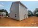 New construction two-story home features gray siding and white trim on an ample lot at 4040 Grommet Ct, Matthews, NC 28105