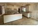 Unfinished kitchen showcasing white cabinets and a spacious island, offering a bright and open layout at 4040 Grommet Ct, Matthews, NC 28105