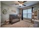 Well-lit Bedroom featuring a window, neutral walls, crib, woven baskets and decor for a tranquil space at 418 Eastway Sw Ln, Conover, NC 28613