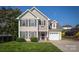 Charming two-story home featuring a well-manicured lawn, attached garage, and classic architectural details at 418 Eastway Sw Ln, Conover, NC 28613