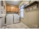 Convenient laundry room with cabinetry, a window for natural light and laundry machines at 418 Eastway Sw Ln, Conover, NC 28613