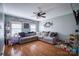 Spacious living room with hardwood floors, large sectional sofa, and ceiling fan offers comfort at 418 Eastway Sw Ln, Conover, NC 28613