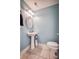 Charming powder room with pedestal sink, oval mirror, and light blue walls at 418 Eastway Sw Ln, Conover, NC 28613