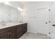 Bathroom featuring double sinks, dark wood cabinets, and ample counter space at 482 Lucky Nw Dr, Concord, NC 28027